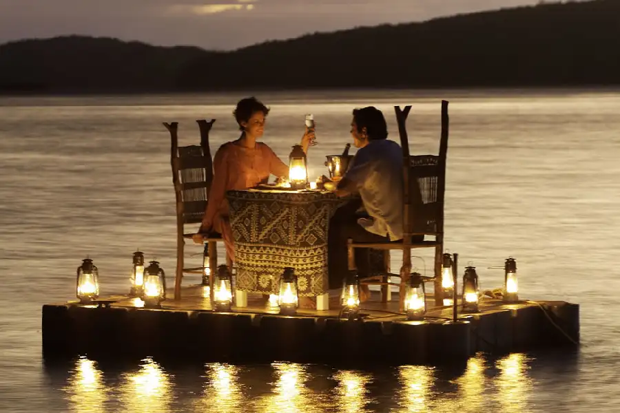 Couple enjoying a romantic candle-lit dinner on an isolated doc on a lake - companion image to "Just Another Valentine" by Gregory Richard Barden - St. Louis